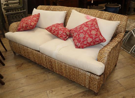 A wove seagrass conservatory sofa W.186cm